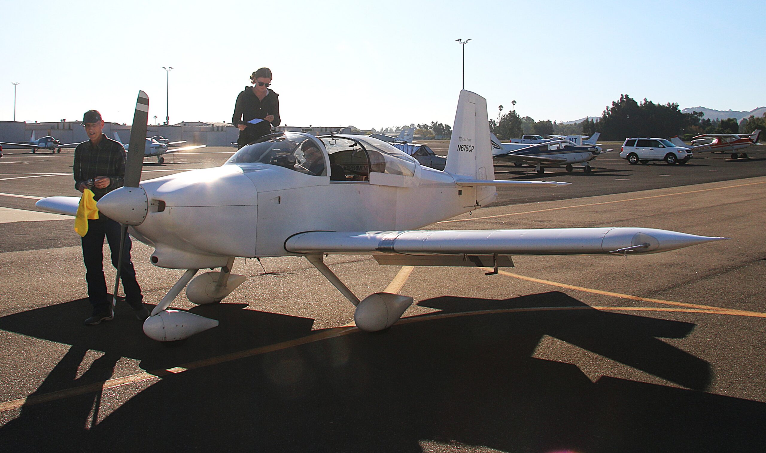 Professors and student prepare the plane for takeoff