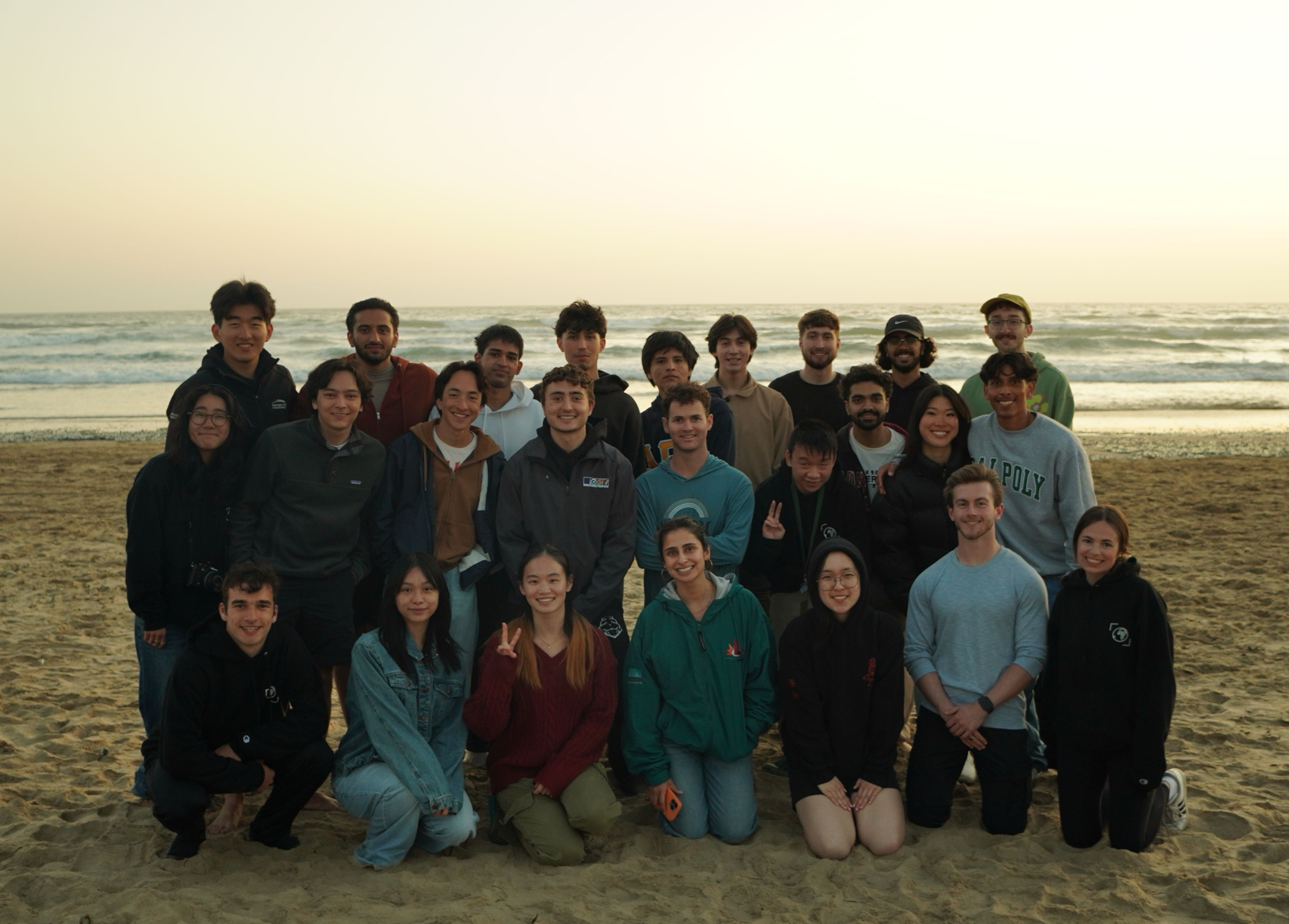 Students gather for a group shot at the beach