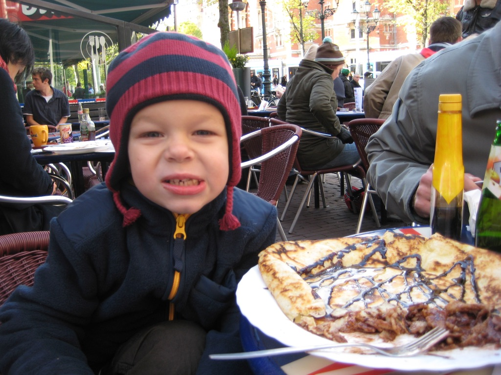 Young boy eats food in Amsterdam