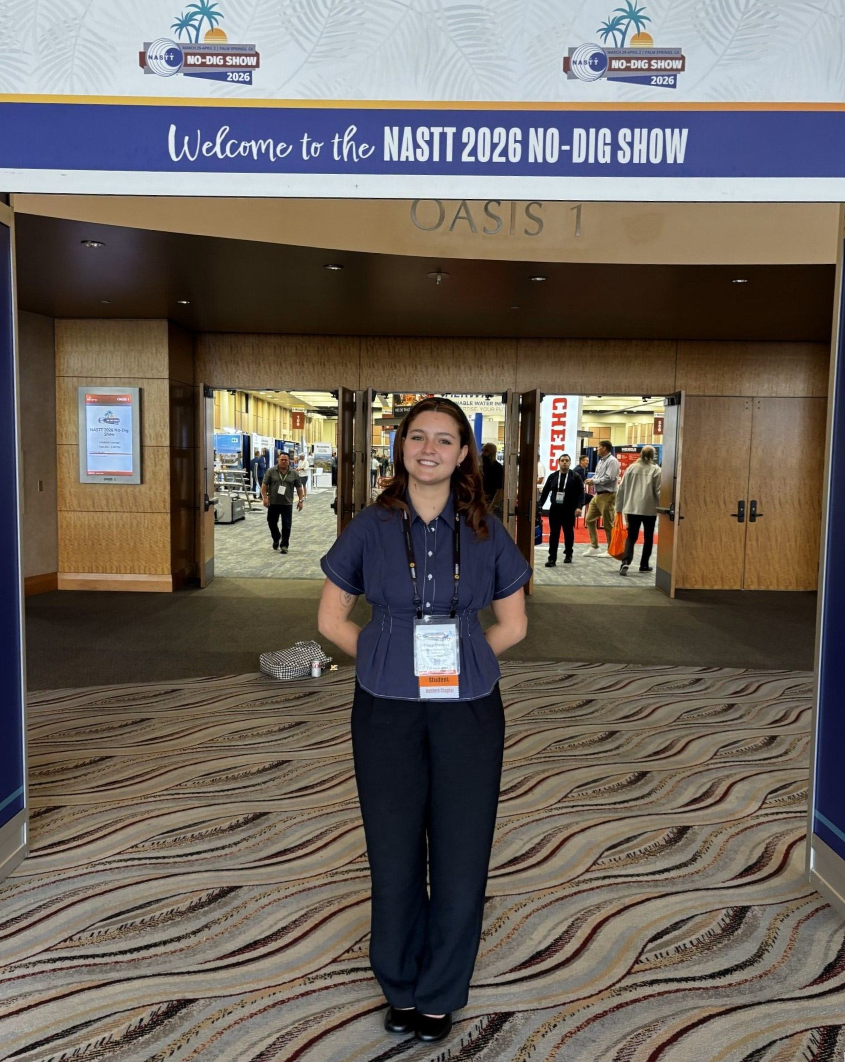 Student poses at conference